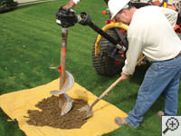 Auguring a hole in the earth for a foundation repair in Anderson