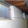 A foundation showing severe inward buckling along the windows in a West Lafayette home.
