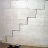 A diagonal stair step crack along the foundation wall of a Plainfield home