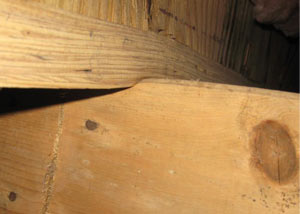 A failing girder showing signs of compression damage in a Indiana home
