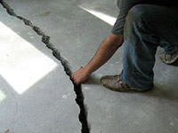 a severely damaged cracked concrete slab floor in Marion