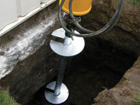 Installing a helical pier system in the earth around a foundation in Fishers