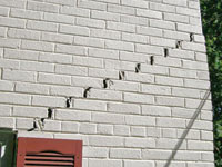 Stair-step cracks showing in a home foundation in Seymour