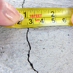 A crack in a poured concrete wall that's showing a normal crack during curing in Huntington