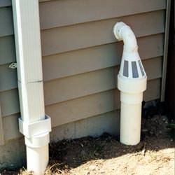 A grated sump pump discharge line fitting in Greenfield