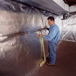 Installation of a radiant heat and vapor barrier on a basement wall in Shelbyville