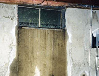 Water pouring out from a basement window in Bloomington